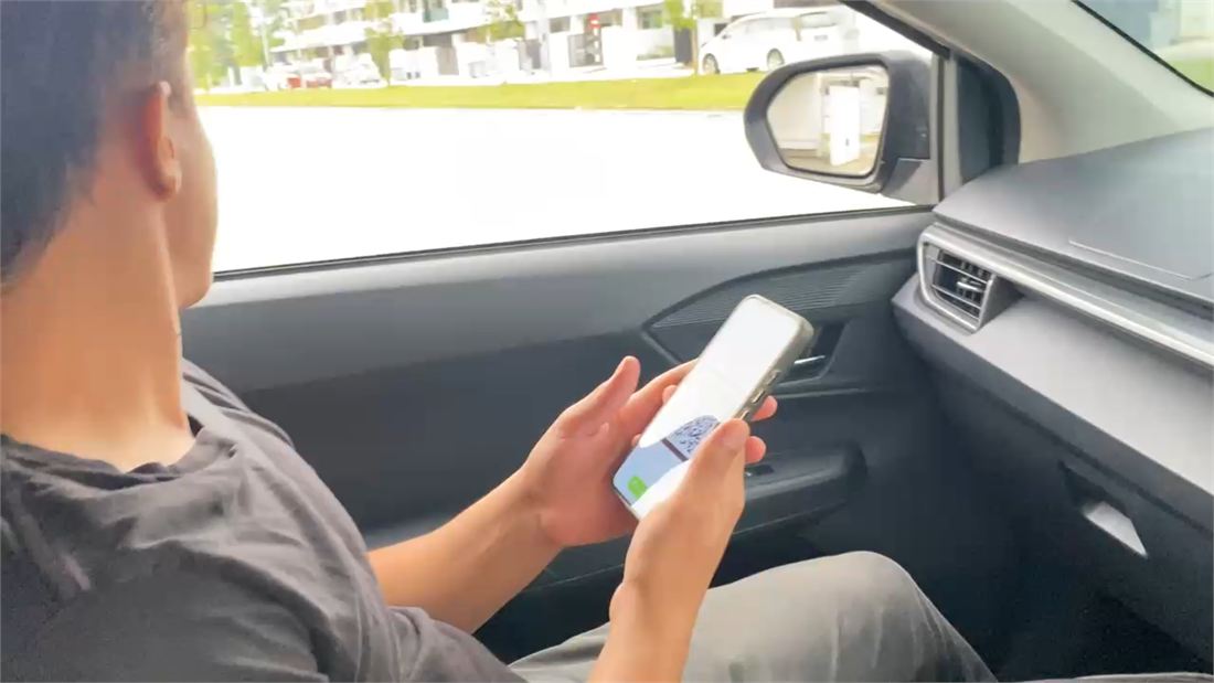 Resident scanning QR access from inside their car
