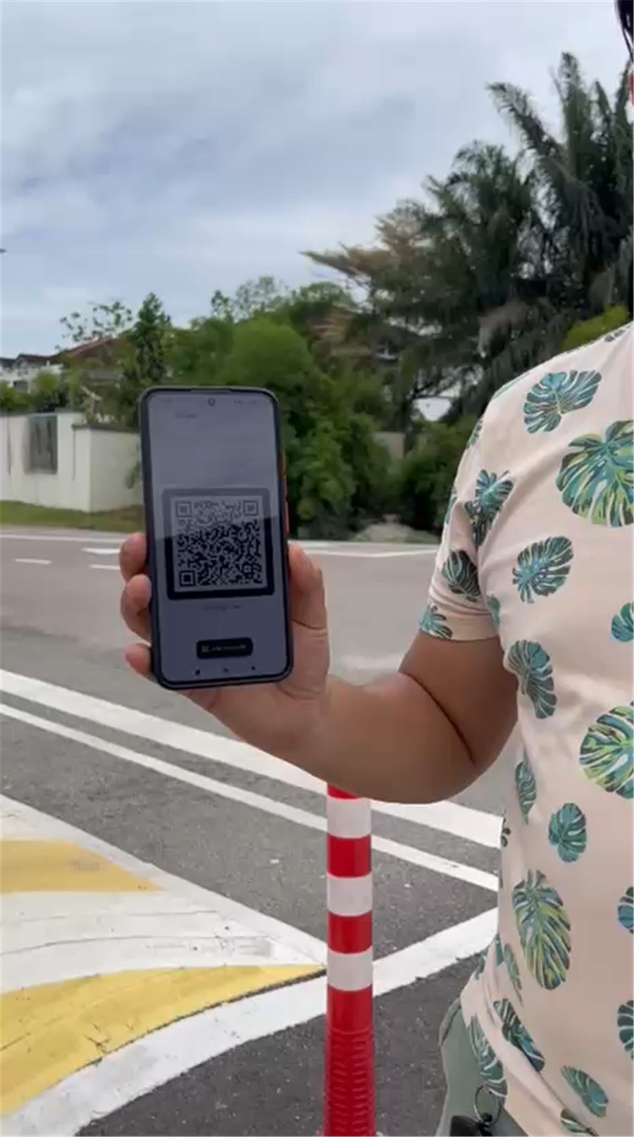 Visitor presenting a MyREDS QR code at the community gate